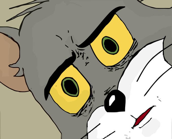 Close-up of Tom Cat from Tom and Jerry with wide yellow eyes, tiny pupils, furrowed brows, and a tense mouth, looking deeply unsettled against a muted beige background.