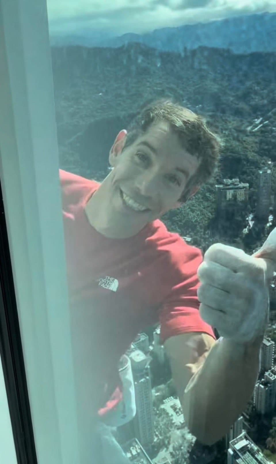 Alex Honnold Thumbs Up From A High-Rise