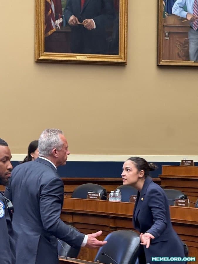 A gray-haired man in a dark suit gestures toward Alexandria Ocasio-Cortez, who faces him with both hands open, inside a congressional chamber. Framed portraits hang on the wall above them, and a MEMELORD.COM watermark appears at the lower right.