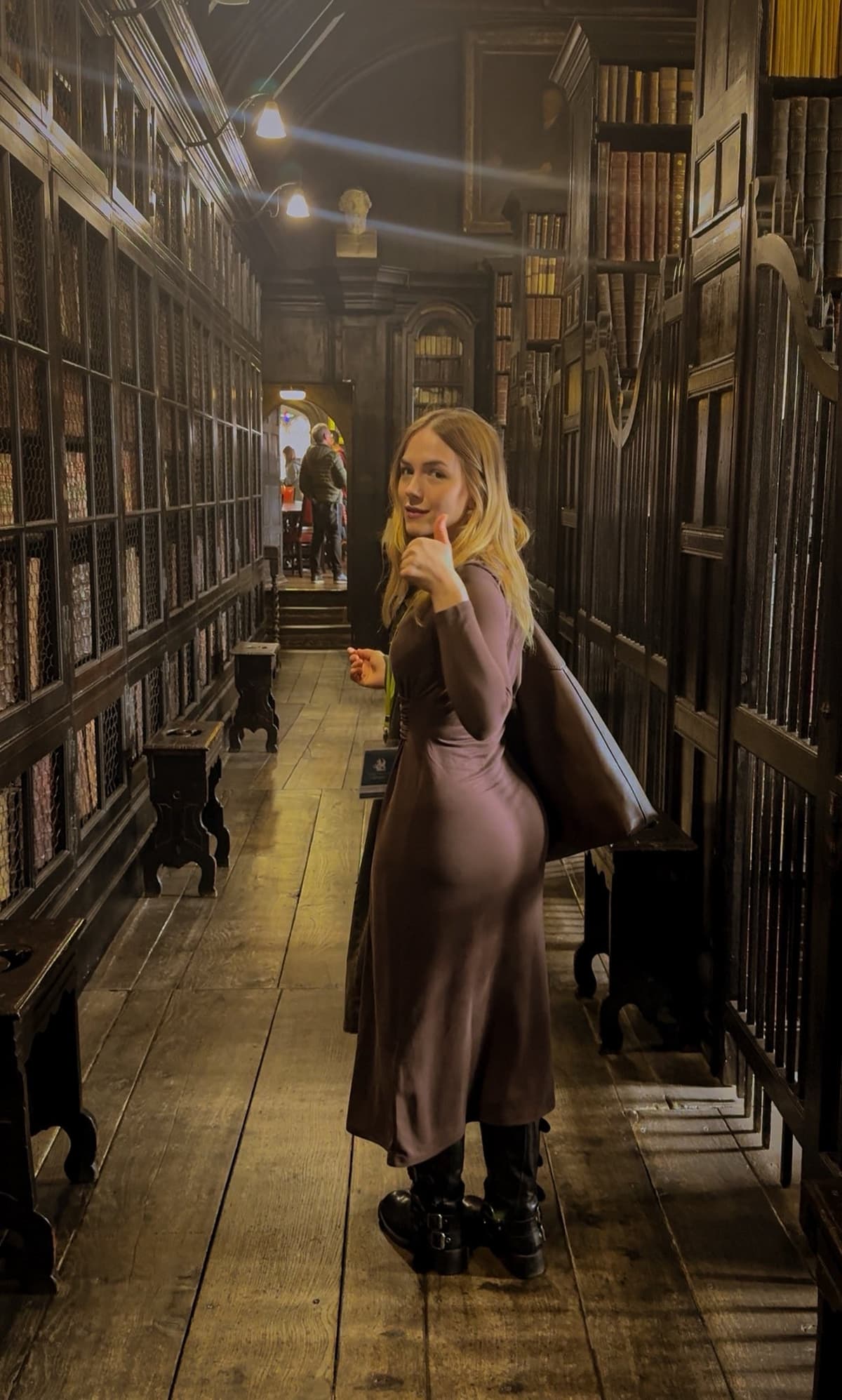 Beth Eleanor Giving A Thumbs-Up In A Historic Library