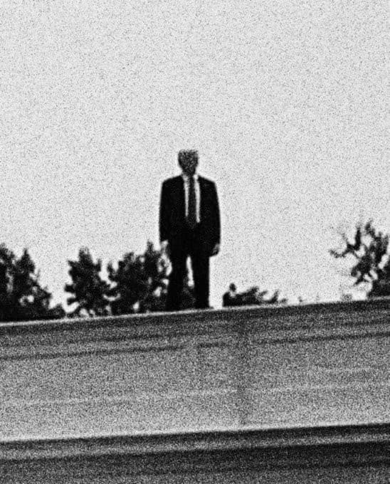 Donald Trump standing on roof B&W