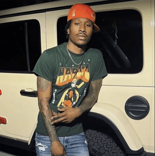Duke Dennis in Front of a Jeep