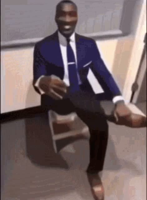 Man In Suit Crossing Legs