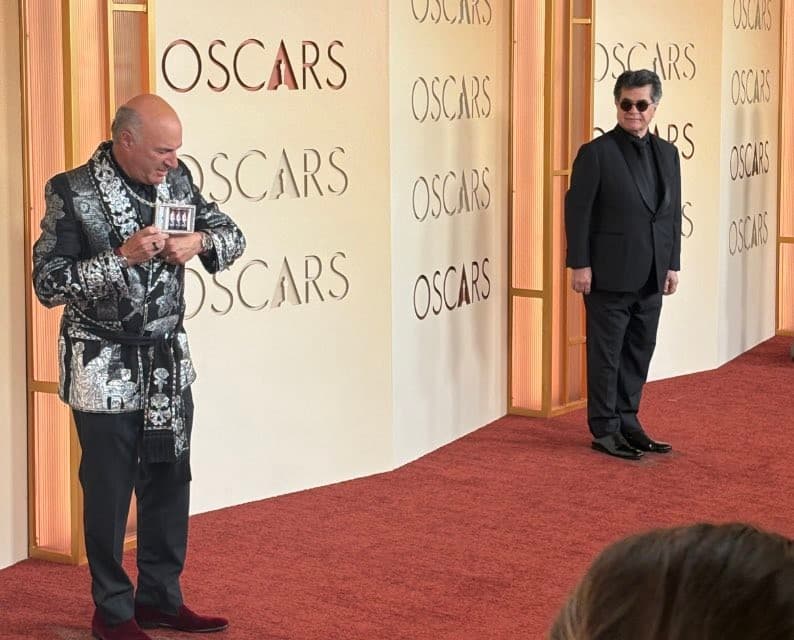 Jafar Panahi looking at Kevin O’Leary - Oscars 2026 Meme Template