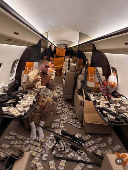 Jake Paul flexing guns and cash on his private jet