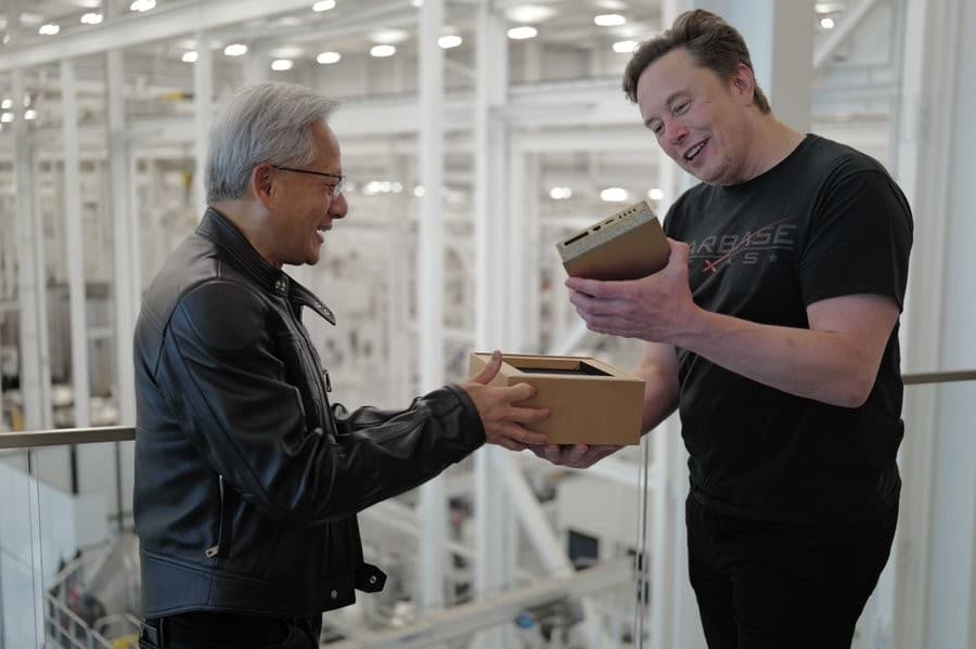 Jensen Huang hand delivering the DGX Spark to Elon Musk