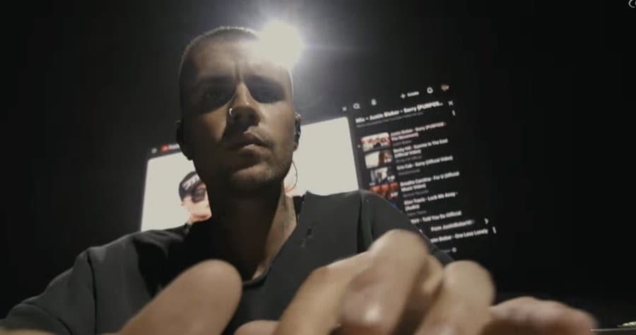 Justin Bieber locked In on his laptop at Coachella