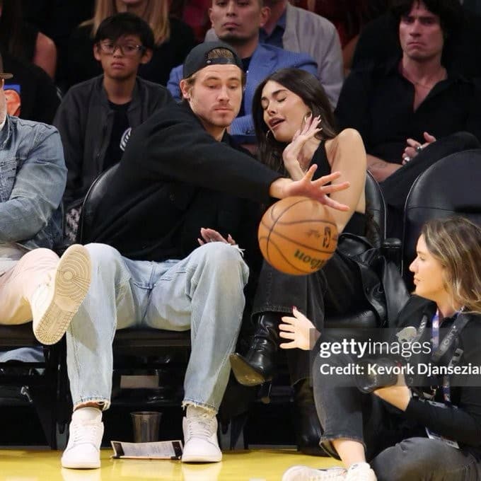 Justin Herbert protecting Madison Beer at the Lakers game