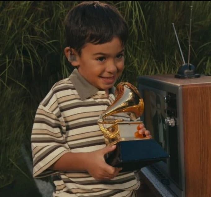 Kid holding a Grammy Super Bowl