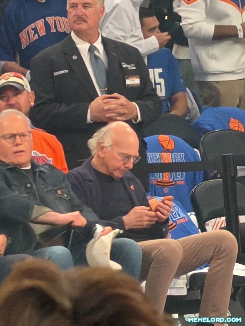 Larry David checking Phone during the game - NBA Finals meme template