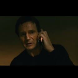 Liam Neeson as Bryan Mills holding a cell phone to his ear with an intense, focused expression in dim lighting, from the Taken phone-call scene.