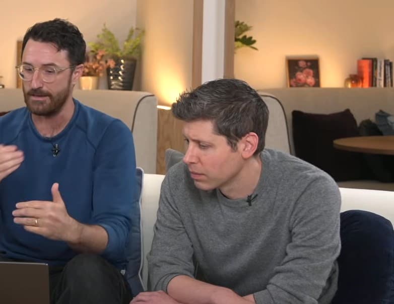 Sam Altman listening to his team