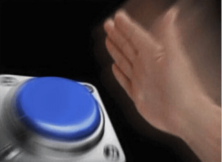 Close-up of a hand hovering over or slapping down on a large blue button. The button is the focal point with dramatic lighting.