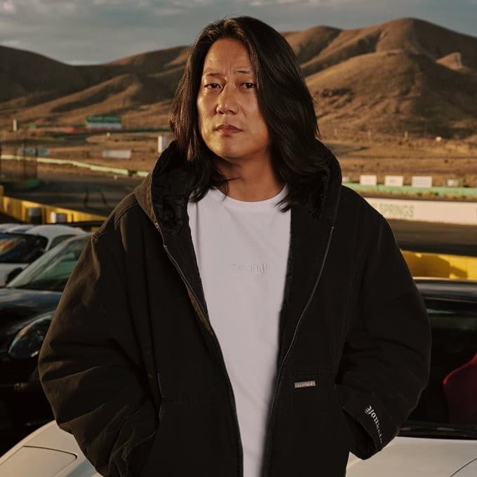 Sung Kang posing in a hooded jacket meme template