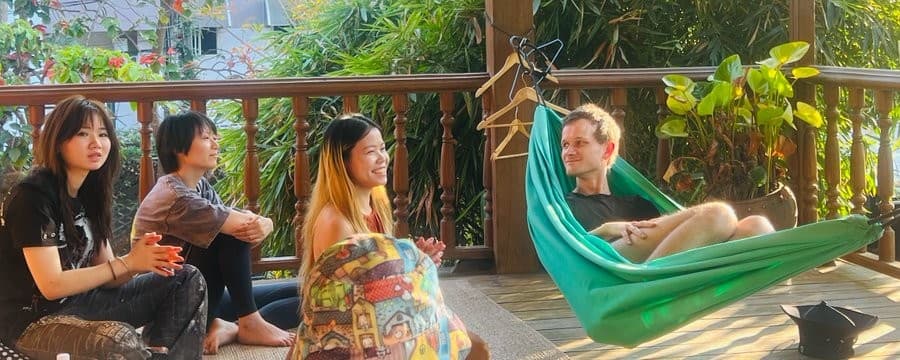 Vitalik Buterin lounging in a hammock with female friends