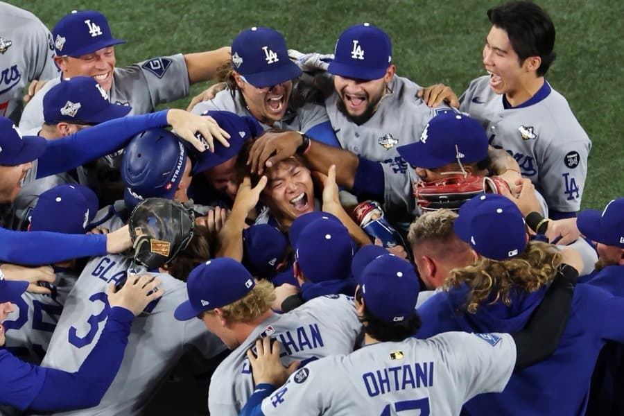 Yoshinobu Yamamoto surrounded by team after Victory MLB