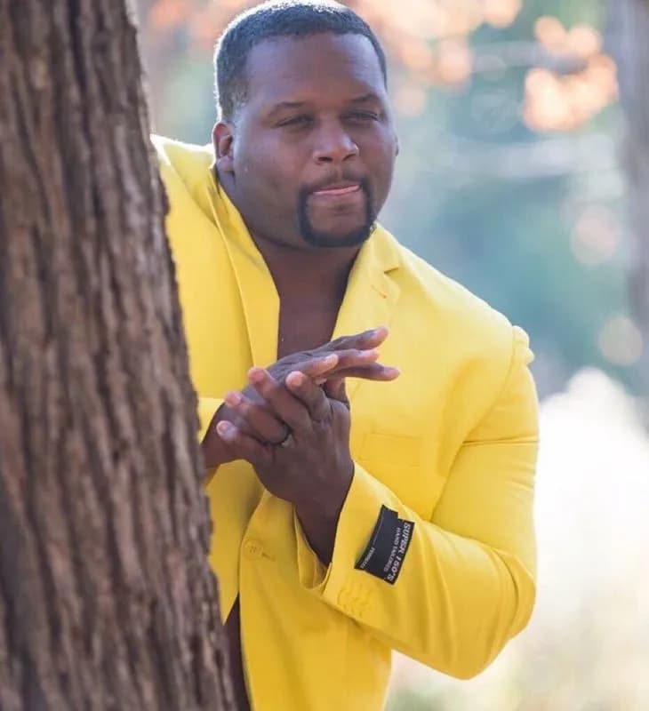 Anthony Adams Rubbing Hands Behind Tree