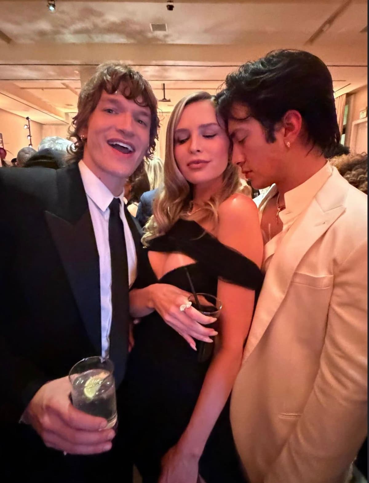 Connor Storrie and Hudson Williams with actress Sara Foster at the 2026 Golden Globes meme template