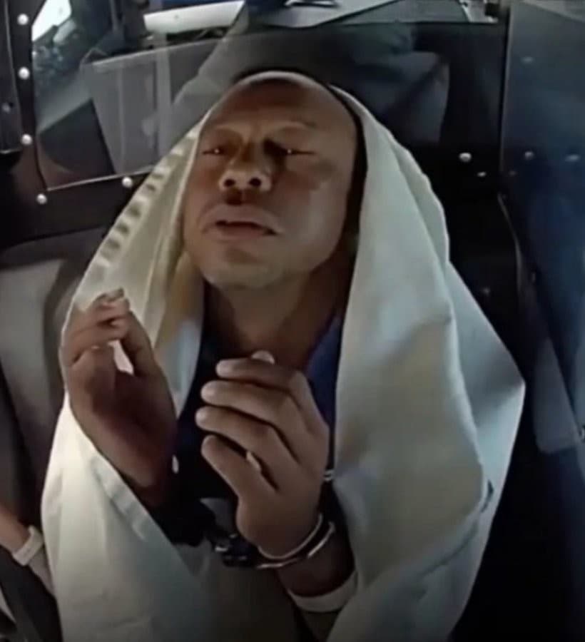 Handcuffed Tiger Woods praying/irritated while in the backseat of a police car