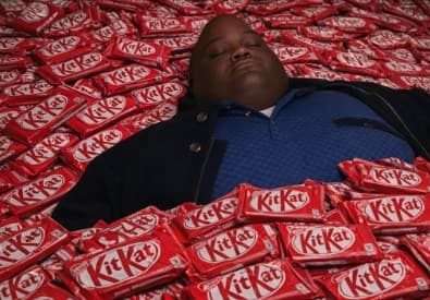 Huell Lays on the pile of Kitkat - 12T KitKat stolen meme template