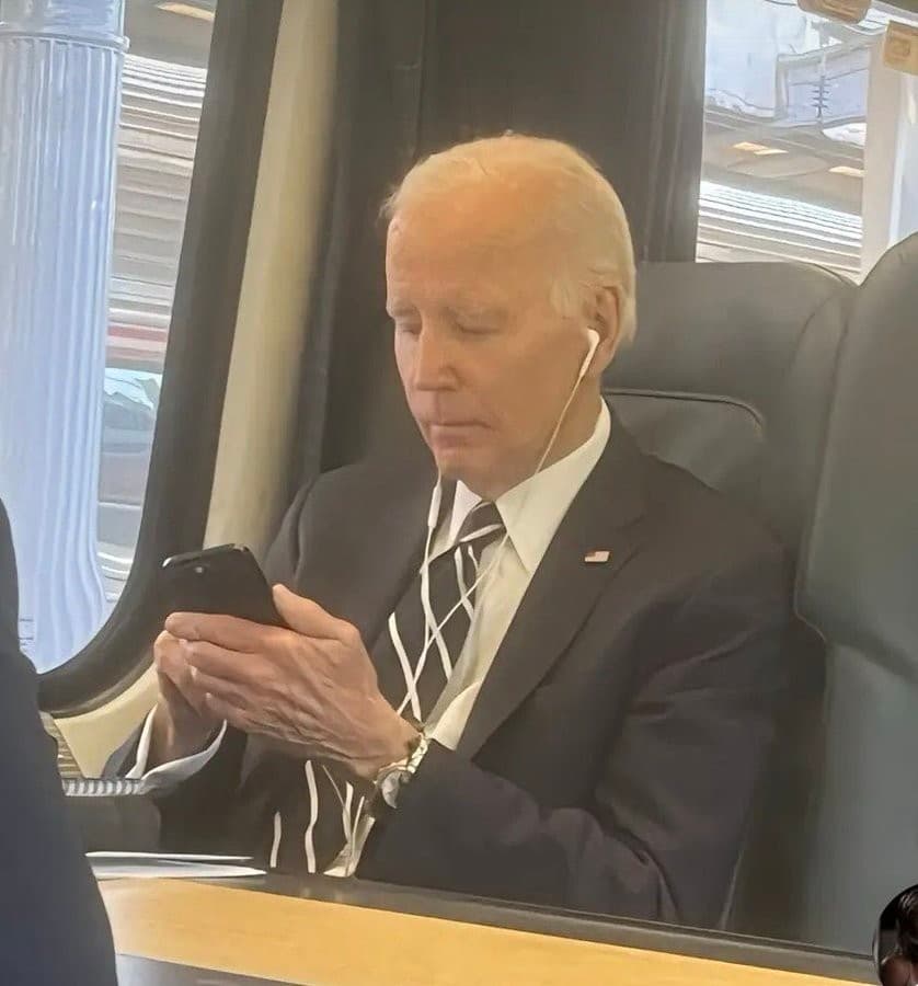 Joe Biden focused on his phone