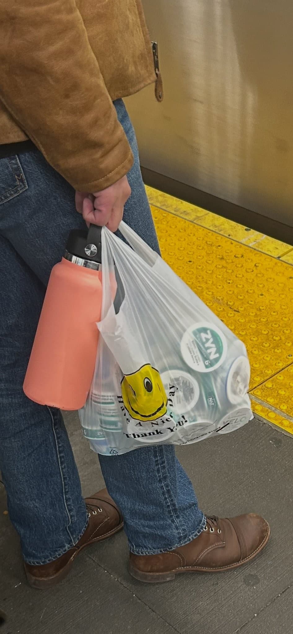 Man carrying a bag stuffed with Zyn nicotine pouches