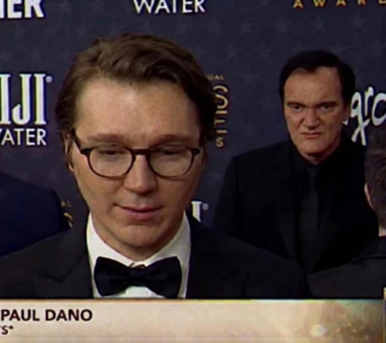 Quentin Tarantino intensely staring at Paul Dano from behind meme template