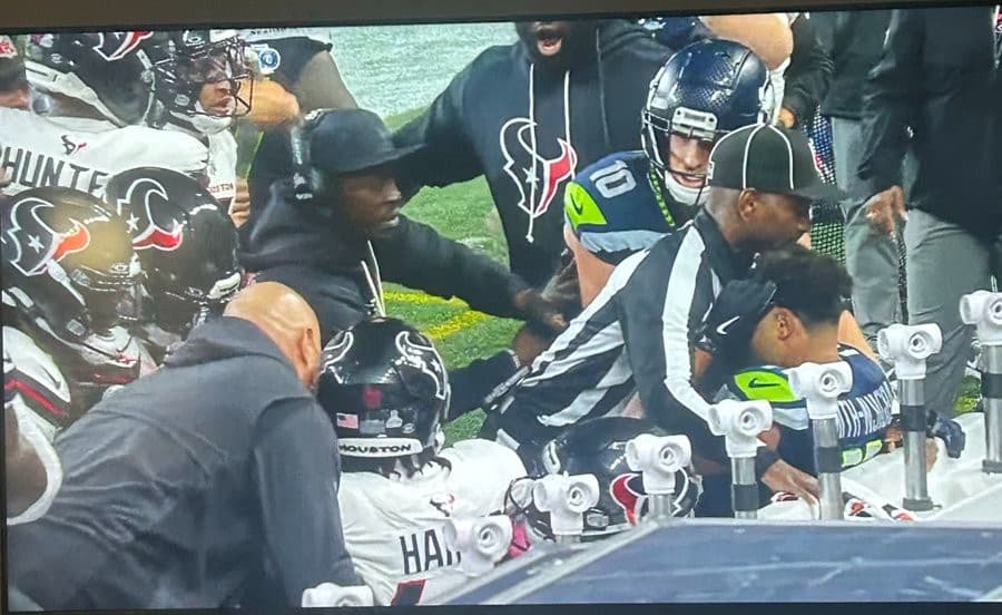 Referee Nate Jones protecting Jaxon Smith-Njigba NFL