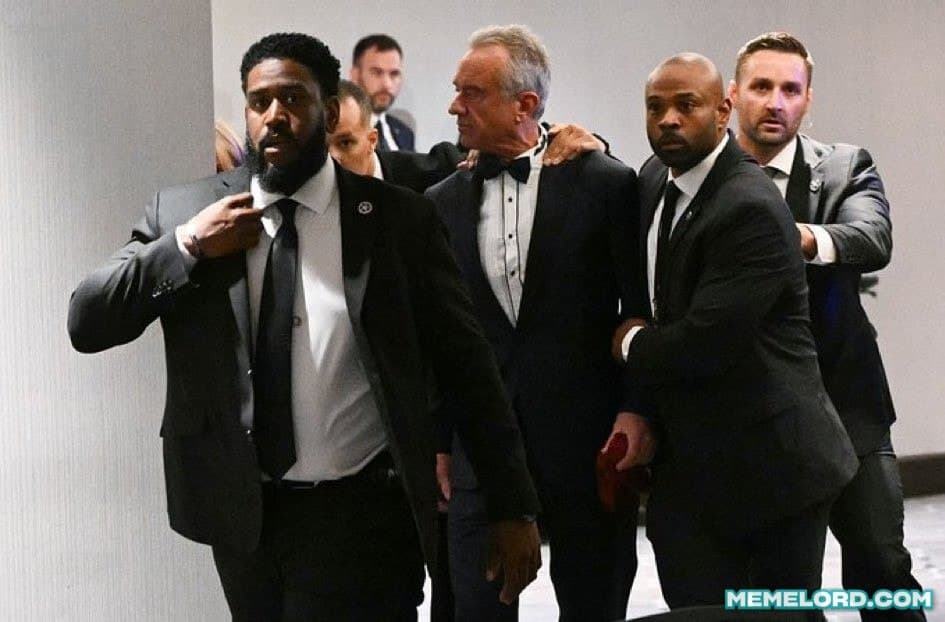 RFK Jr. in a tuxedo being escorted out - White House firing meme template