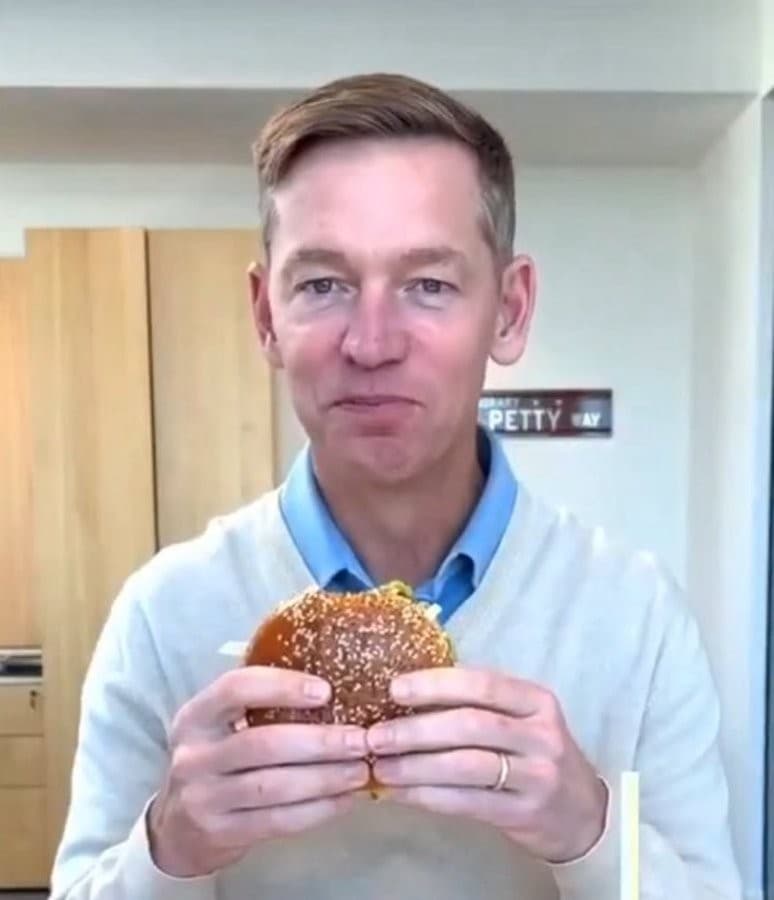 The CEO of McDonalds eating the new big arch meal but taking a TINY bite